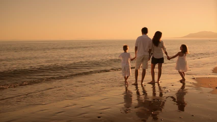A family walking along the beach at sunset — the path to parenthood with Militta